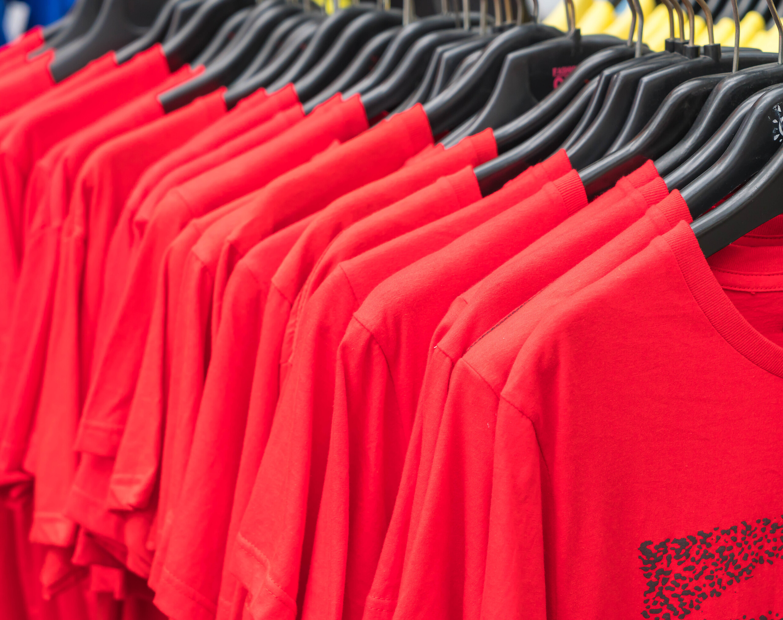 Clothes hang on shelf Promote your business with Apparel from Streamline Print and Design.